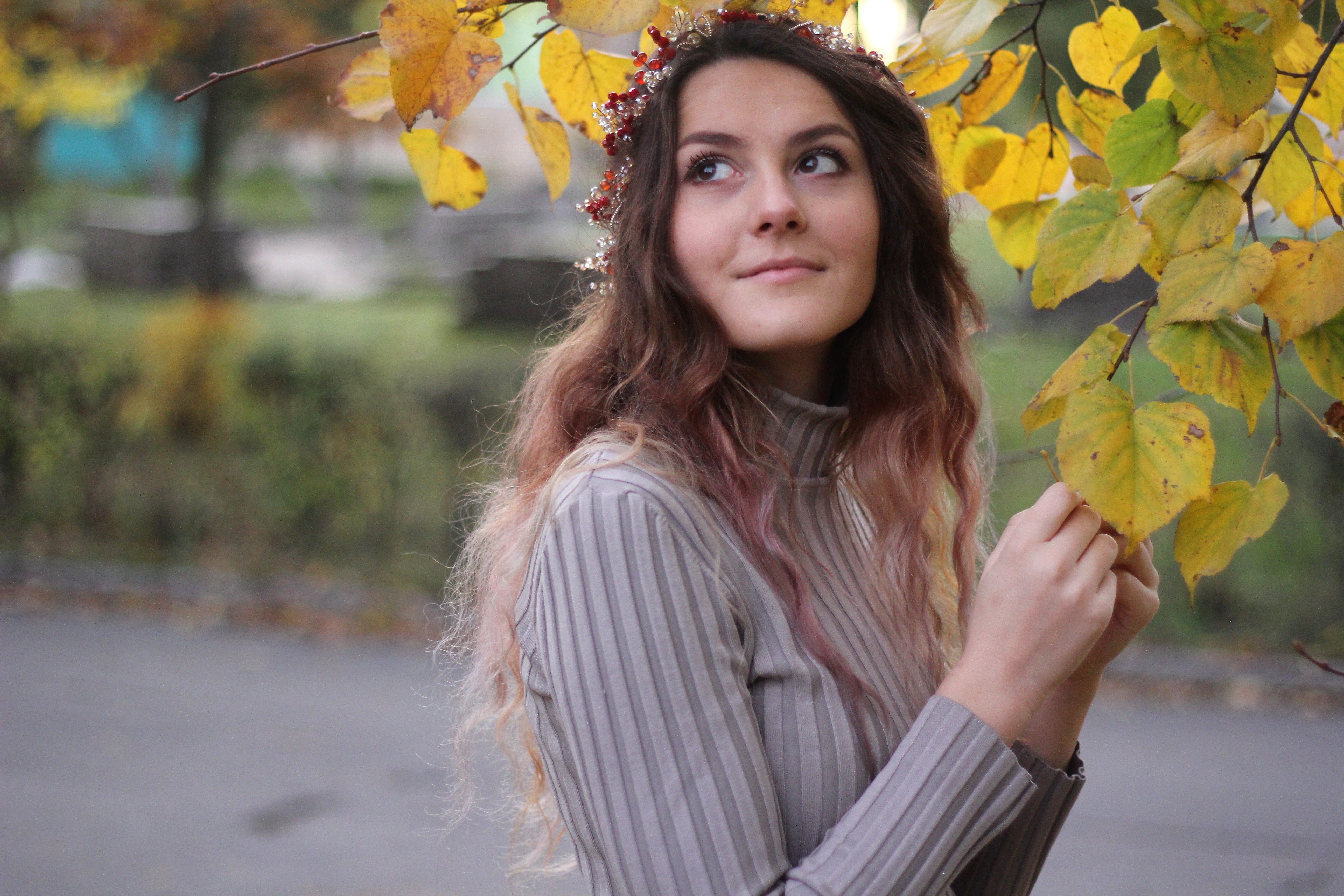 Smiling girl in a wedding hair wreath in autumn