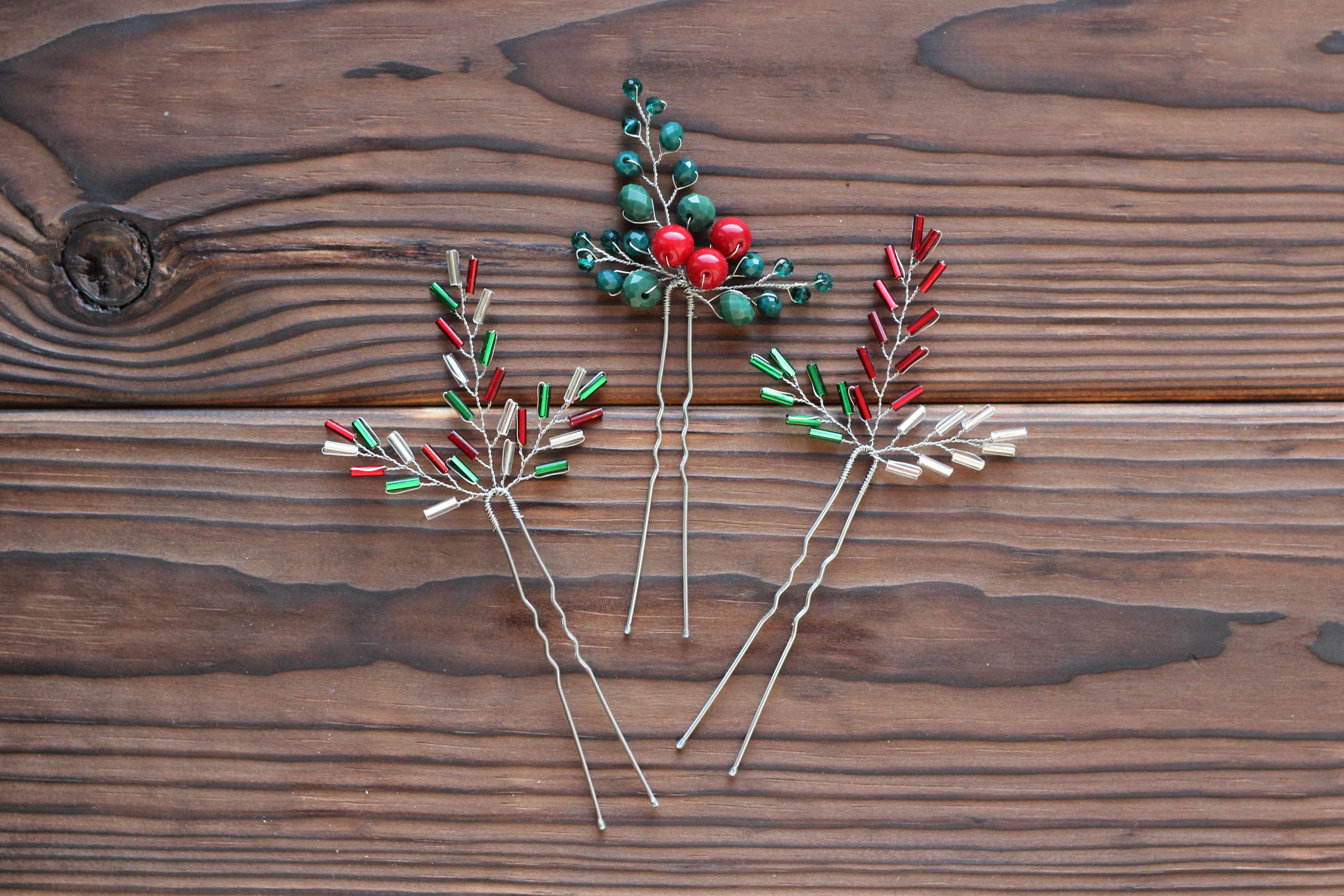 3 cute festive red, green, and silver hair pins from beads on the dark wood background