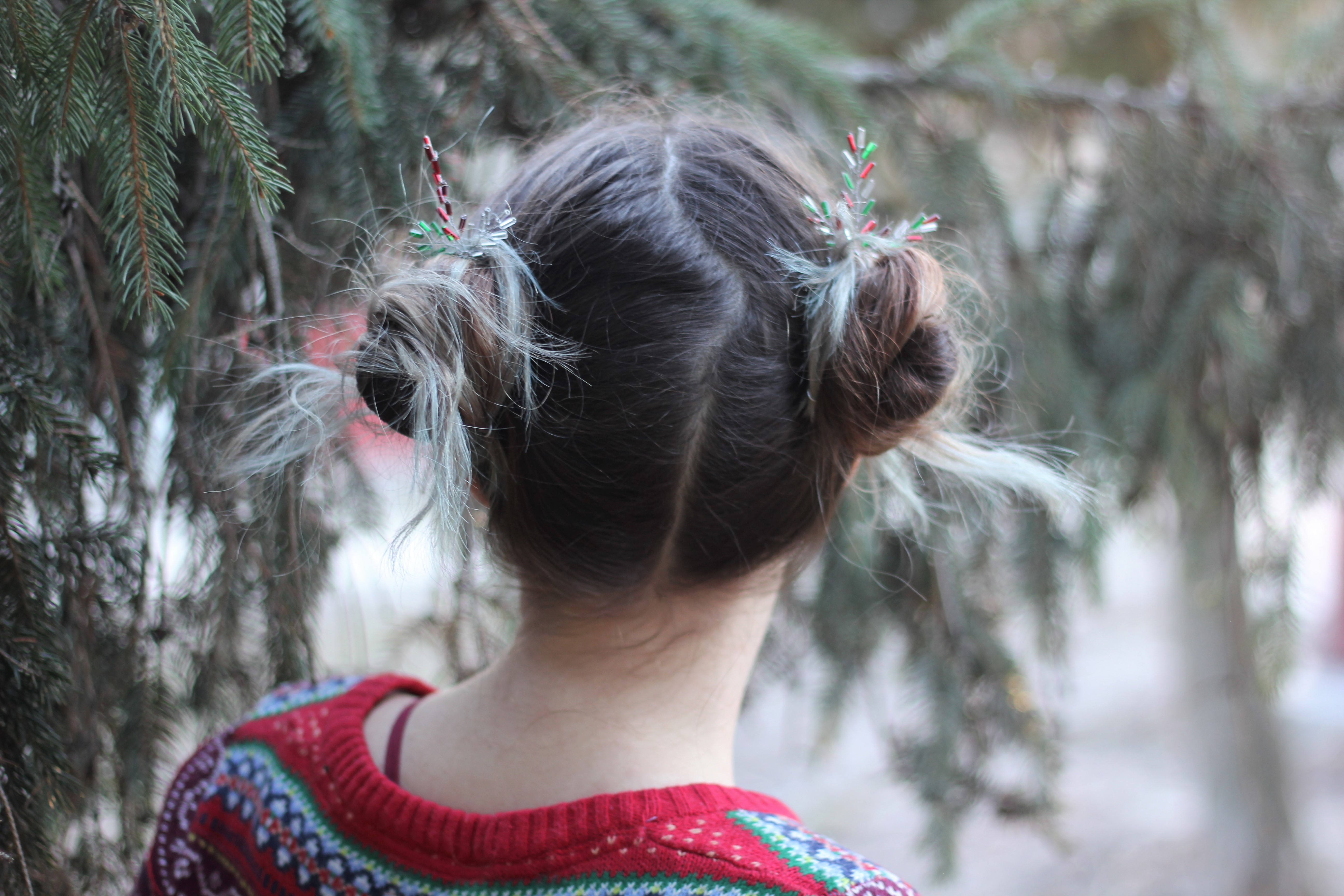 Two messy hair buns with cute Christmas inspired hair pins